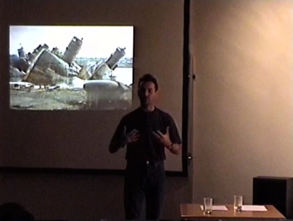 Simon Herbert delivering his lecture "Action Art in the United Kingdom" at Some Assembly Required, 7a*11d 1998