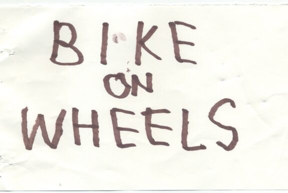 Notebook page from Step 2 with the words 'Bike on Wheels' in thick black marker