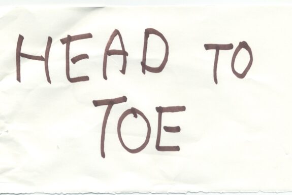 Notebook page from Step 2 with the words 'Head to toe' in thick black marker