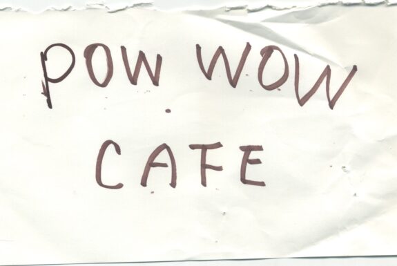 Notebook page from Step 2 with the words 'Pow wow cafe' in thick black marker