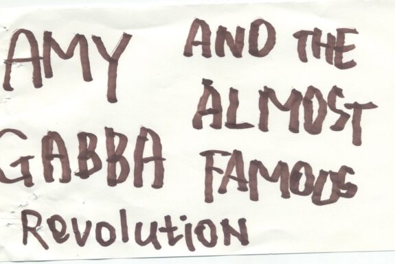 Notebook page from Step 2 with the words 'Amy Gabba and the almost famous revolution' in thick black marker
