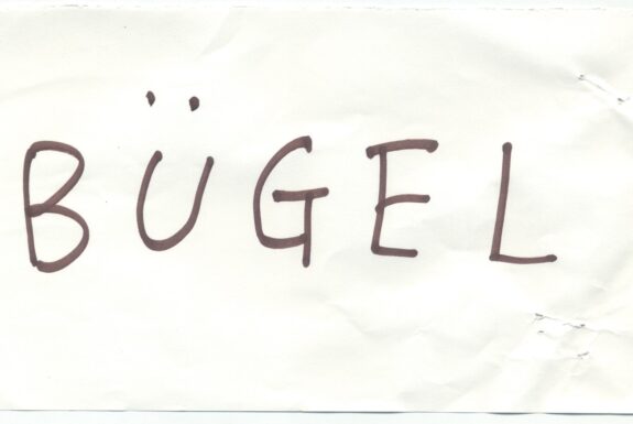 Notebook page from Step 2 with the word 'Bügel' in thick black marker