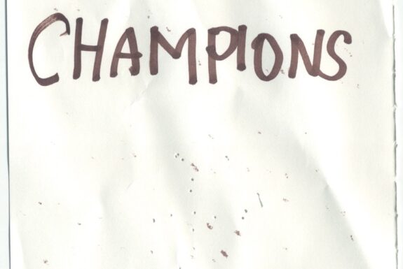 Notebook page from Step 2 with the words 'Iron maiden champions' in thick black marker