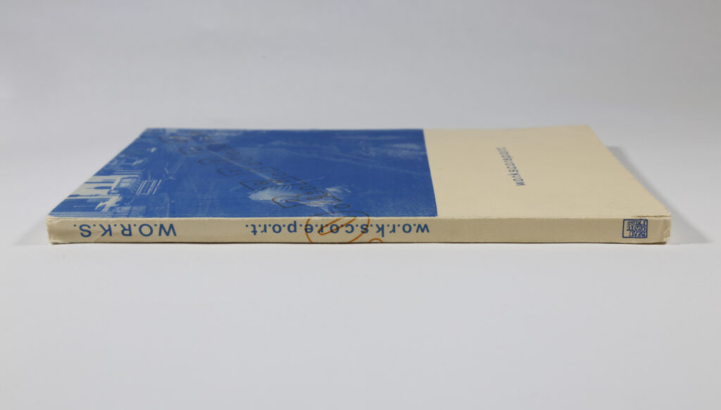 Image of W.O.R.K.S.C.O.R.E.P.O.R.T. (1975) publication with blue and white cover sitting on its side
