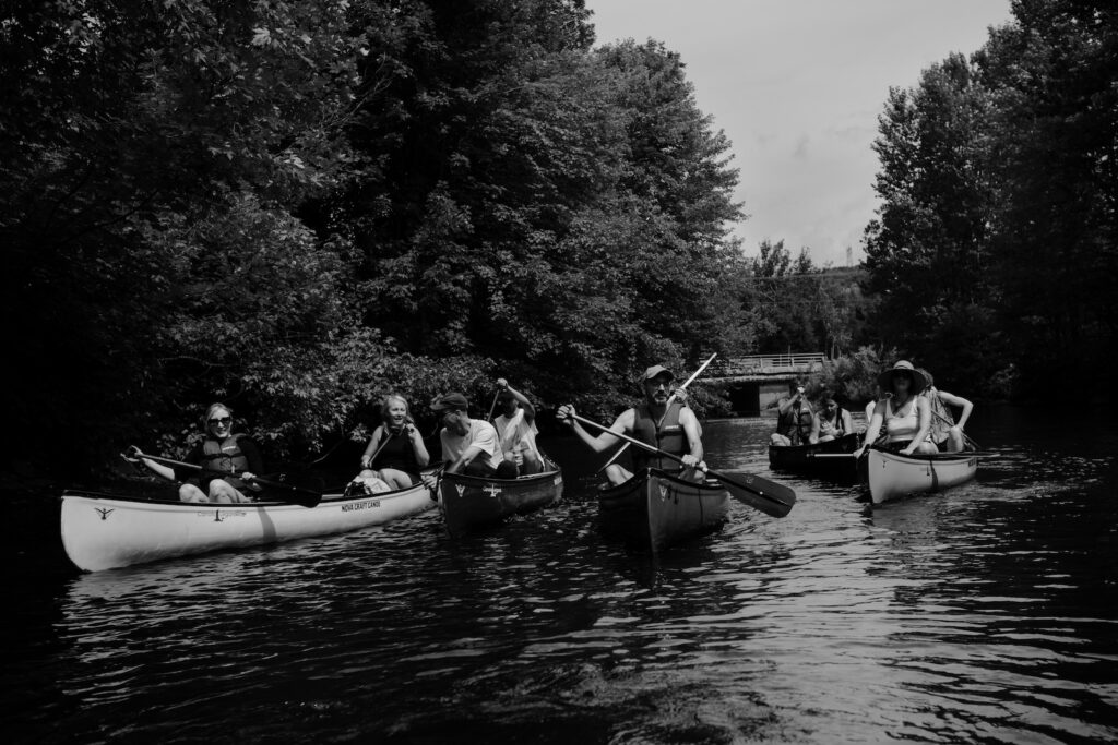 black and white image of people canoeing on a river, documenting the Yahndawa' residency project by VU